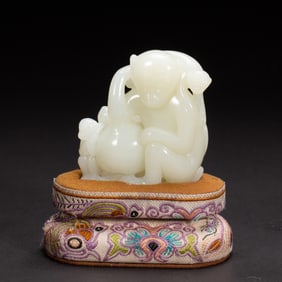A CARVED WHITE JADE MONKEY