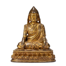 A BRONZE-GILT SEATED LAMA