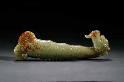 A FINE CARVED YELLOW JADE FISH-DRAGON DAGGER HANDLE