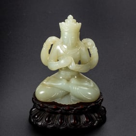 A CARVED WHITE JADE BODHISATTVA