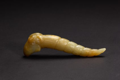 A CARVED JADE SILK WORM ORNAMENT