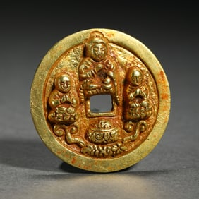 A SILVER-GILT BUDDHIST COIN