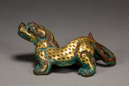 A GOLD INLAID BRONZE MYTHICAL BEAST