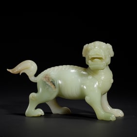A FINE CARVED WHITE JADE MYTHICAL BEAST BIXIU