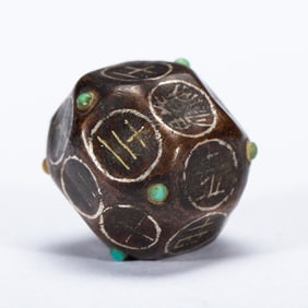 A TURQUOISE INLAID GOLD AND SILVER DECORATED DICE