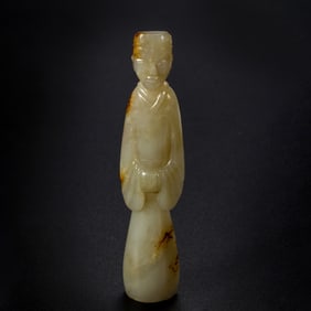 A CARVED JADE STANDING FIGURE