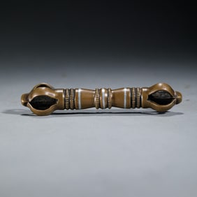 A TIBETAN IRON INLAID COPPER VAJRA