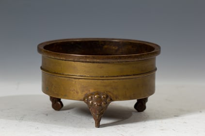 A BRONZE TRIPOD CENSER