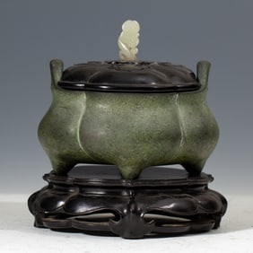 A BRONZE TRIPOD CENSER WITH COVER