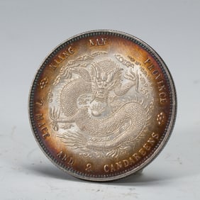 A SILVER DRAGON COIN