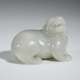 A CARVED WHITE JADE MYTHICAL BEAST