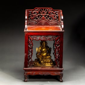 A BRONZE-GILT JAMBHALA WITH ANNATTO-WOOD SHRINE