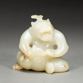 A CARVED WHITE JADE MYTHICAL BEAST