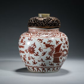 A RED ENAMELED PHOENIX JAR WITH COVER