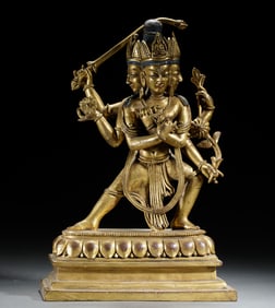 A TIBETAN BRONZE-GILT STANDING PROTECTOR
