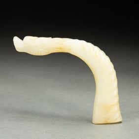 A CARVED WHITE JADE DRAGON HEAD HANDLE