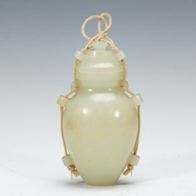 AN INSCRIBED WHITE JADE VASE WITH COVER