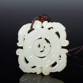 A CARVED WHITE JADE PENDANT