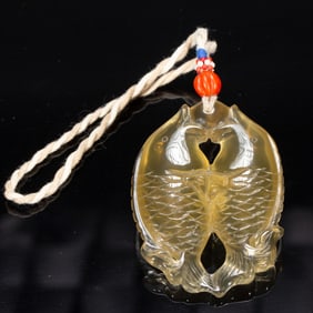 A CARVED CITRINE DOUBLE FISHES PENDANT
