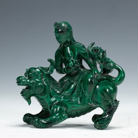 A CARVED MALACHITE GUANYIN