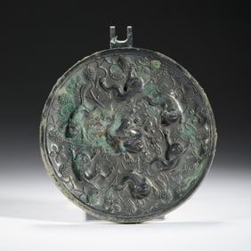A BRONZE CIRCULAR MIRROR