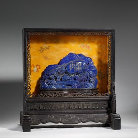 A CARVED LAPIS BOULDER