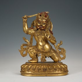 A SINO-TIBETAN BRONZE-GILT ACALAVAJRA