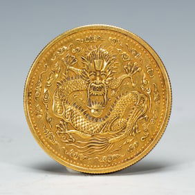 A SILVER-GILT DRAGON COIN