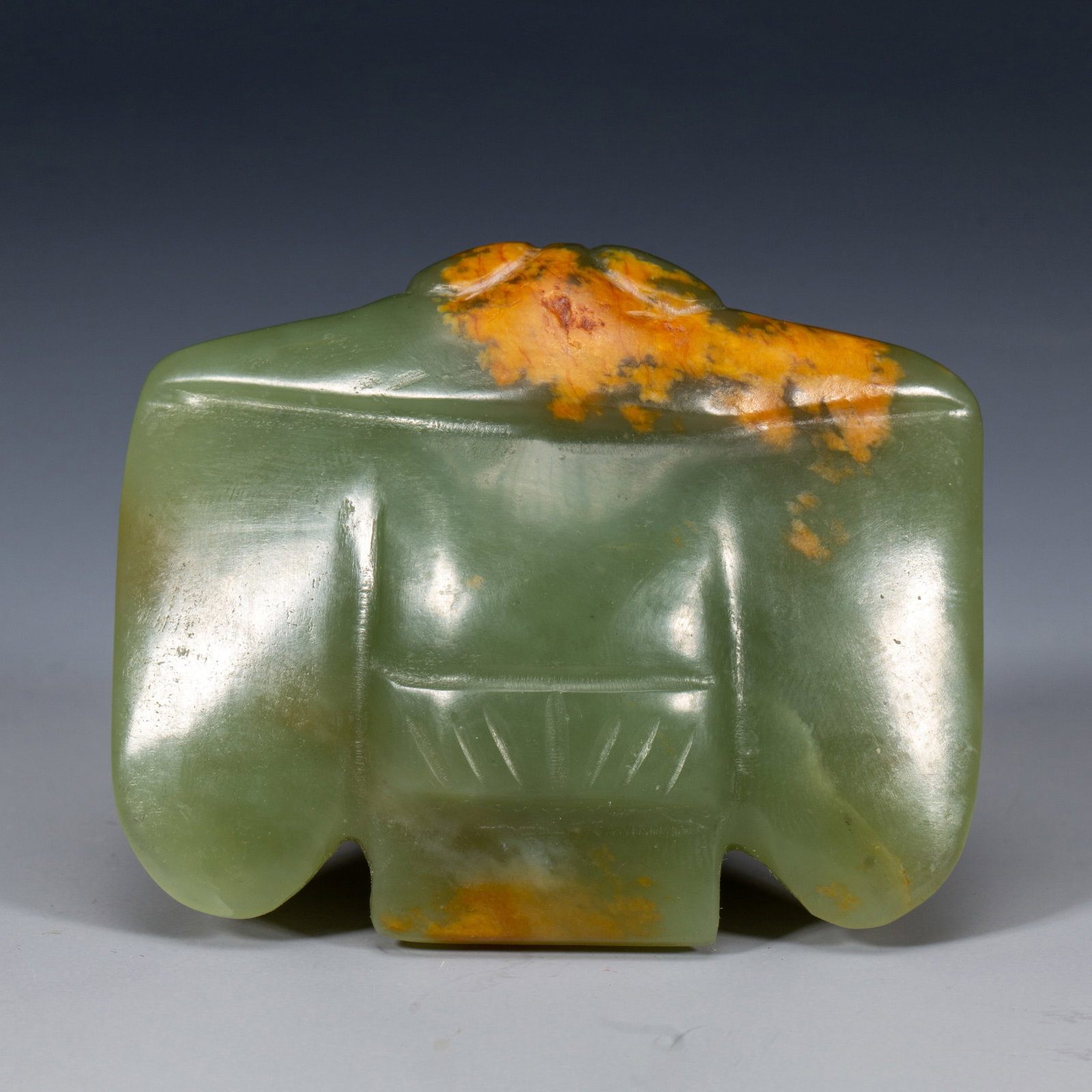 A JADE CARVING OF MYTHICAL BIRD: A JADE CARVING OF MYTHICAL BIRD The flattened pendant is carved in the form of a bird with a rounded head and outspread wings incised with vertical parallel lines. Dimensions: L. 5.5 cm. W. 4.5 cm. We