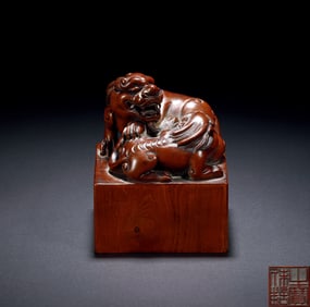A CARVED HARDWOOD LION SEAL