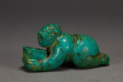A CARVED TURQUOISE FIGURE
