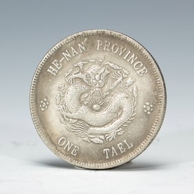 A SILVER DRAGON COIN