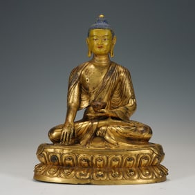 A BRONZE-GILT SEATED SHAKYAMUNI
