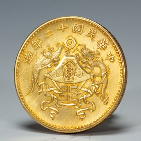 A CHINESE SILVER-GILT COIN