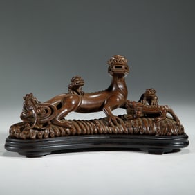A CARVED HUANGHUALI CHILONG BRUSHREST