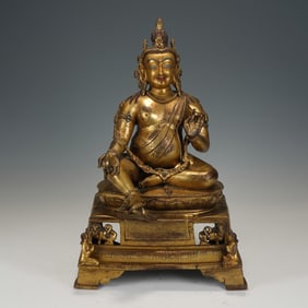 A BRONZE-GILT JAMBHALA