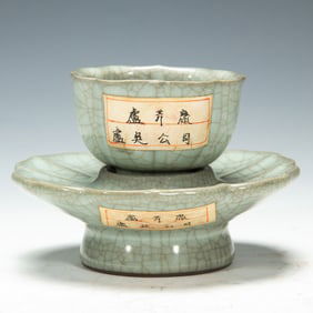 A GUAN-WARE TEA CUP WITH STAND