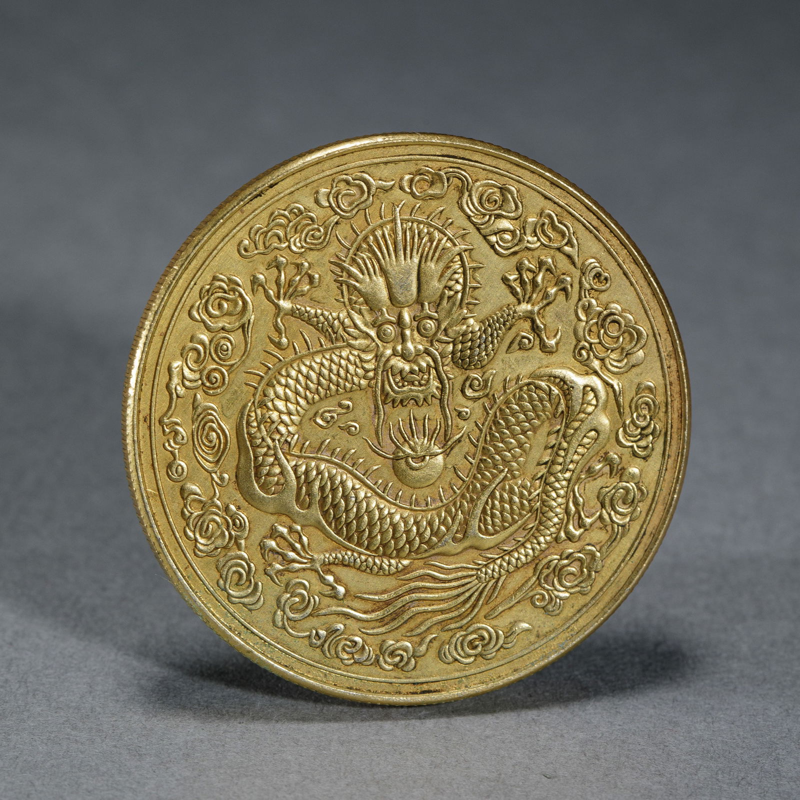 A SILVER-GILT DRAGON COIN (1 of 9)