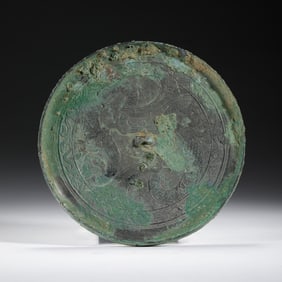 A BRONZE CIRCULAR MIRROR