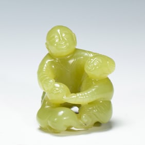 A CARVED YELLOW JADE BOYS GROUP