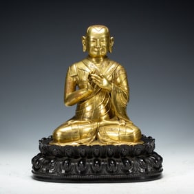 A BRONZE-GILT SEATED LAMA