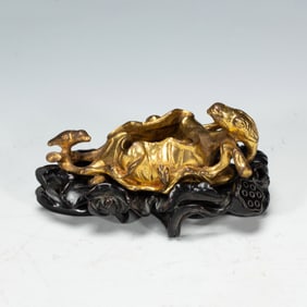 A BRONZE-GILT WASHER