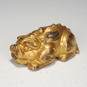 A BRONZE-GILT MYTHICAL BEAST