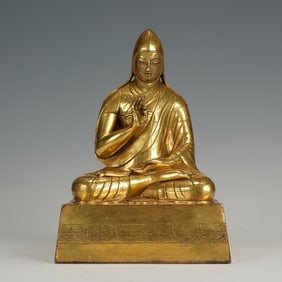 A BRONZE-GILT SEATED LAMA