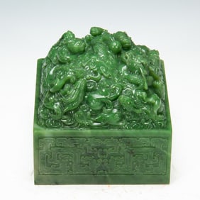 A FINE CARVED SPINACH GREEN JADE DRAGON SEAL