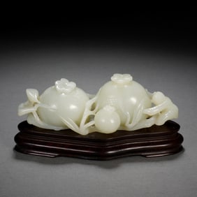 A CARVED WHITE JADE MONKEY WITH POMEGRANATE
