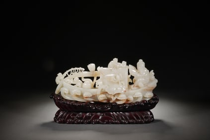 A CARVED WHITE JADE BOAT