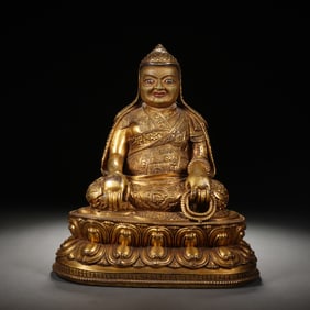 A BRONZE-GILT SEATED LAMA