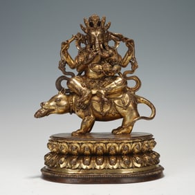 A BRONZE-GILT SEATED GANESHA