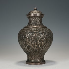 A SILVER FIGURAL STORY JAR WITH COVER